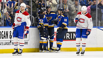 Mar 25, 2025; St. Louis, Missouri, USA;  St. Louis Blues defenseman Philip Broberg (6) is congratulated by left wing Jake Neighbours (63) and center Robert Thomas (18) after scoring against the Montreal Canadiens during the third period at Enterprise Center. Mandatory Credit: Jeff Curry-Imagn Images