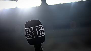 A microphone bearing the logo of DAZN is seen at the end of...