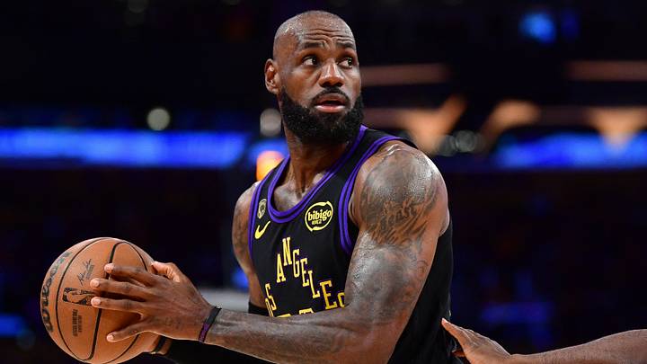 Los Angeles Lakers forward LeBron James (23) controls the ball against Oklahoma City Thunder guard Luguentz Dort (5) during the first half in game four of the second round of the 2026 NBA Playoffs at Crypto.com Arena. 