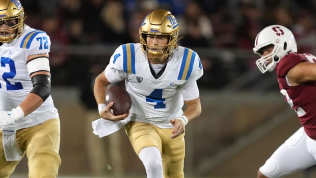 UCLA Bruins quarterback Ethan Garbers on a rushing attempt during a college football game.