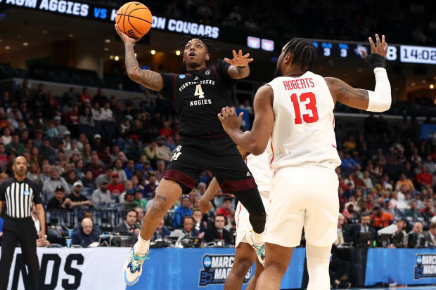 Texas A&M Aggies guard Wade Taylor IV (4) shoots against Houston Cougars forward J'Wan Roberts (13). 