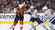Jan 7, 2025; Philadelphia, Pennsylvania, USA; Philadelphia Flyers right wing Tyson Foerster (71) battles against Toronto Maple Leafs defenseman Philippe Myers (51) and defenseman Morgan Rielly (44) during the third period at Wells Fargo Center. Mandatory Credit: Eric Hartline-Imagn Images