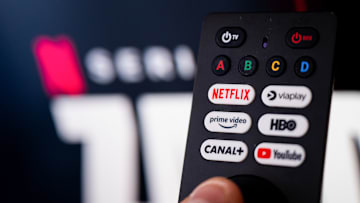 In this photo illustration a Netflix logo seen on a TV...