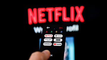 In this photo illustration a Netflix logo seen on a TV...