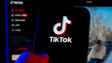 In this photo illustration, a TikTok logo seen displayed on...