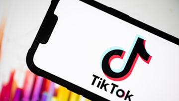 In this photo illustration, the TikTok logo seen displayed...