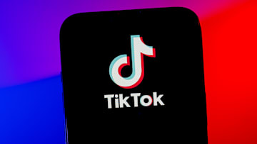 In this photo illustration, a TikTok logo seen displayed on...