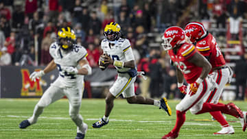 Nov 22, 2025; College Park, Maryland, USA;  Michigan Wolverines quarterback Bryce Underwood (19) rolls out to pass during the second half against the Maryland Terrapins at SECU Stadium. Mandatory Credit: Tommy Gilligan-Imagn Images