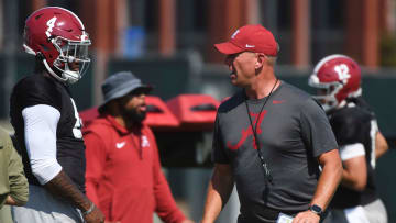 The Alabama Crimson Tide football team works out Sunday morning in practice as they prepare for the 2024 season. Alabama quarterback Jalen Milroe (4) listens to directions from Alabama head coach Kalen DeBoer.