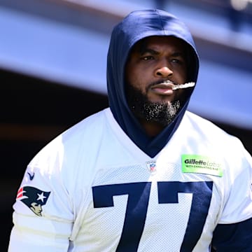 Jun 10, 2024; Foxborough, MA, USA; New England Patriots offensive tackle Chukwuma Okorafor (77) walks to the practice fields for minicamp at Gillette Stadium. Mandatory Credit: Eric Canha-Imagn Images