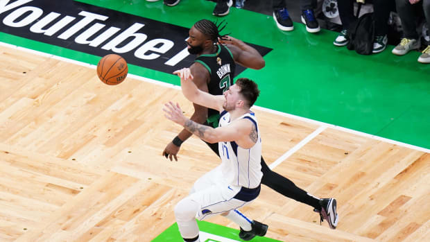 June 9, 2024;  Boston, Massachusetts, USA;  Boston Celtics guard Jaylen Brown (7) steals the ball from Dallas Mavericks guard Luka Doncic (77) in the third quarter during Game 2 of the 2024 NBA Finals at TD Garden.  Mandatory Credit: David Butler II-USA TODAY Sports