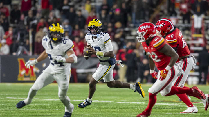 Nov 22, 2025; College Park, Maryland, USA;  Michigan Wolverines quarterback Bryce Underwood (19) rolls out to pass during the second half against the Maryland Terrapins at SECU Stadium. Mandatory Credit: Tommy Gilligan-Imagn Images