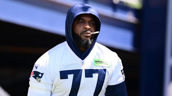 Jun 10, 2024; Foxborough, MA, USA; New England Patriots offensive tackle Chukwuma Okorafor (77) walks to the practice fields for minicamp at Gillette Stadium. Mandatory Credit: Eric Canha-Imagn Images