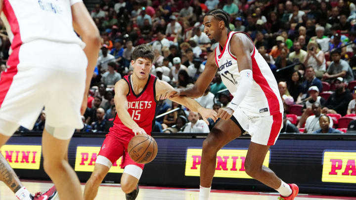 Jul 14, 2024; Las Vegas, NV, USA; Houston Rockets guard Reed Sheppard (15) dribbles against Washington Wizards forward Alex Sarr (12) during the fourth quarter at Thomas & Mack Center. Mandatory Credit: Stephen R. Sylvanie-USA TODAY Sports