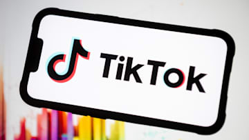 In this photo illustration, the TikTok logo seen displayed...