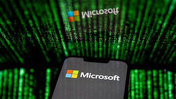In this photo illustration, the Microsoft logo seen...