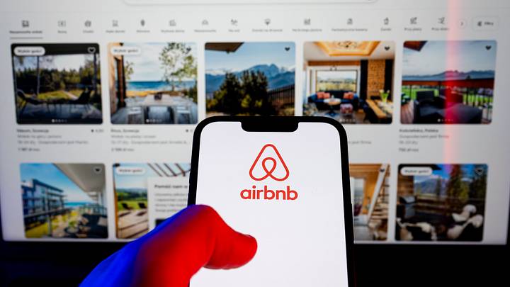 In this photo illustration, an Airbnb logo seen displayed on In this photo illustration, an Airbnb logo seen displayed on
