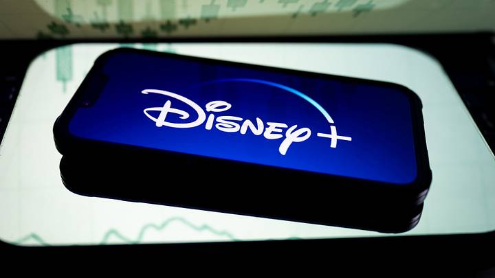 In this photo illustration, a Disney+ logo seen displayed on