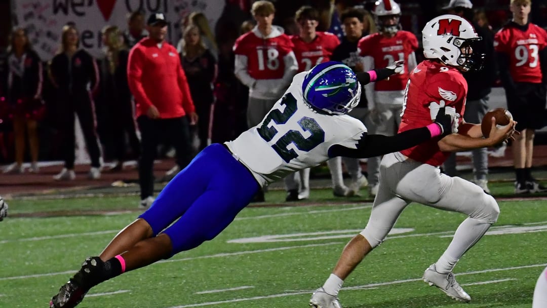Milford quarterback Austin Hardin runs out of the would-be tackle of Winton Woods' Justin Hill (22) at the Winton Woods vs. Milford Eastern Cincinnati Conference football game, Oct. 7, 2022.

Mw 114
