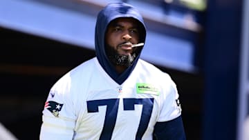 Jun 10, 2024; Foxborough, MA, USA; New England Patriots offensive tackle Chukwuma Okorafor (77) walks to the practice fields for minicamp at Gillette Stadium. Mandatory Credit: Eric Canha-Imagn Images