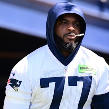 Jun 10, 2024; Foxborough, MA, USA; New England Patriots offensive tackle Chukwuma Okorafor (77) walks to the practice fields for minicamp at Gillette Stadium. Mandatory Credit: Eric Canha-Imagn Images