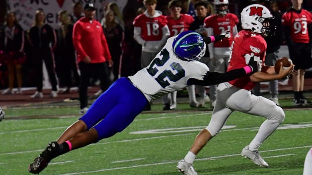 Winton Woods' Justin Hill (22) lunges after the Milford (Ohio) quarterback in 2022.