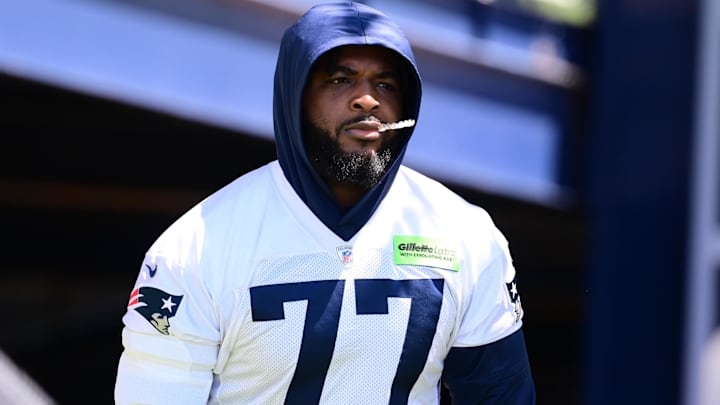 Jun 10, 2024; Foxborough, MA, USA; New England Patriots offensive tackle Chukwuma Okorafor (77) walks to the practice fields for minicamp at Gillette Stadium. Mandatory Credit: Eric Canha-Imagn Images