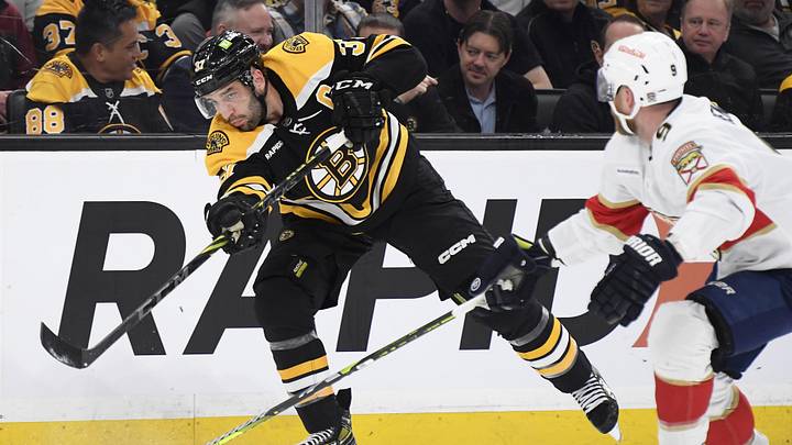 Apr 26, 2023; Boston, Massachusetts, USA; Boston Bruins center Patrice Bergeron (37) shoots the puck on goal while Florida Panthers center Sam Bennett (9) defends during the first period in game five of the first round of the 2023 Stanley Cup Playoffs at TD Garden. Mandatory Credit: Bob DeChiara-Imagn Images Apr 26, 2023; Boston, Massachusetts, USA; Boston Bruins center Patrice Bergeron (37) shoots the puck on goal while Florida Panthers center Sam Bennett (9) defends during the first period in game five of the first round of the 2023 Stanley Cup Playoffs at TD Garden. Mandatory Credit: Bob DeChiara-Imagn Images