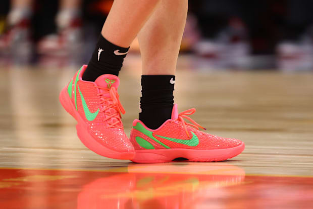 Caitlin Clark's red and green Nike Kobe sneakers.