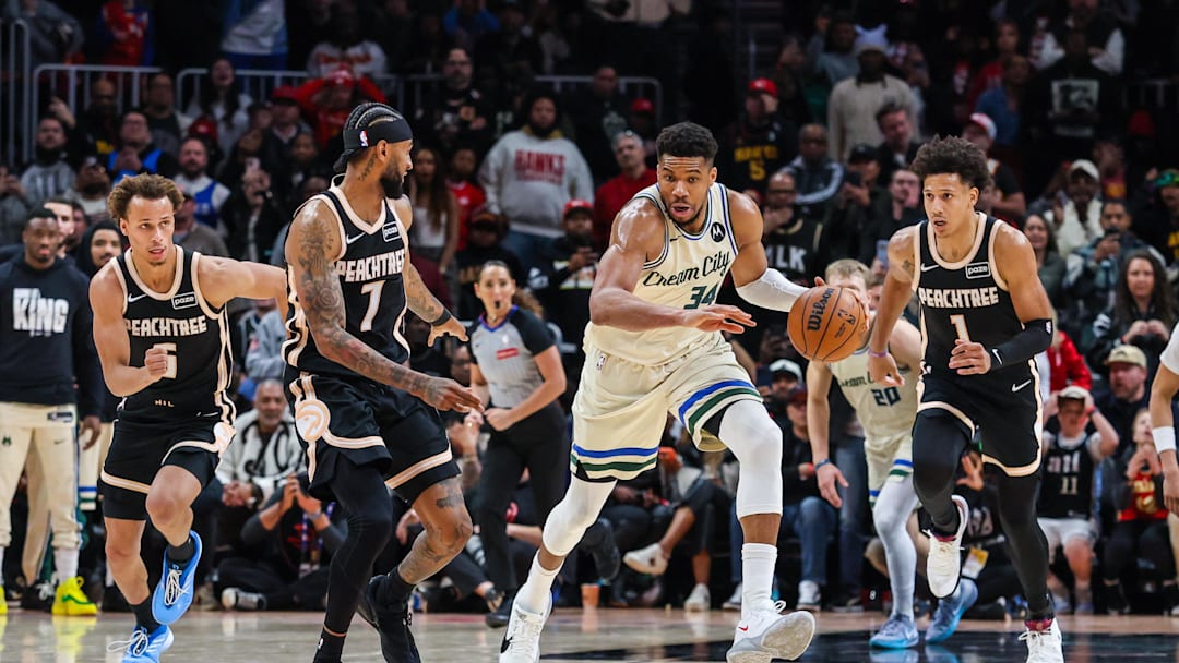 Jan 19, 2026; Atlanta, Georgia, USA; Milwaukee Bucks forward Giannis Antetokounmpo (34) steals the ball against Atlanta Hawks guard Dyson Daniels (5), guard Nickeil Alexander-Walker (7) and forward Jalen Johnson (1) during the fourth quarter at State Farm Arena. Mandatory Credit: Jordan Godfree-Imagn Images