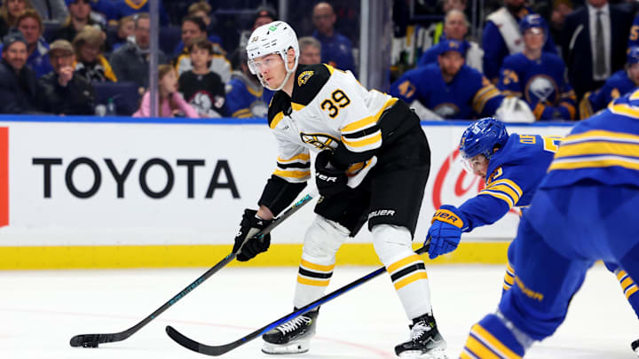 Apr 6, 2025; Buffalo, New York, USA;  Boston Bruins center Morgan Geekie (39) looks to take a shot on goal during the first period against the Buffalo Sabres at KeyBank Center. Mandatory Credit: Timothy T. Ludwig-Imagn Images