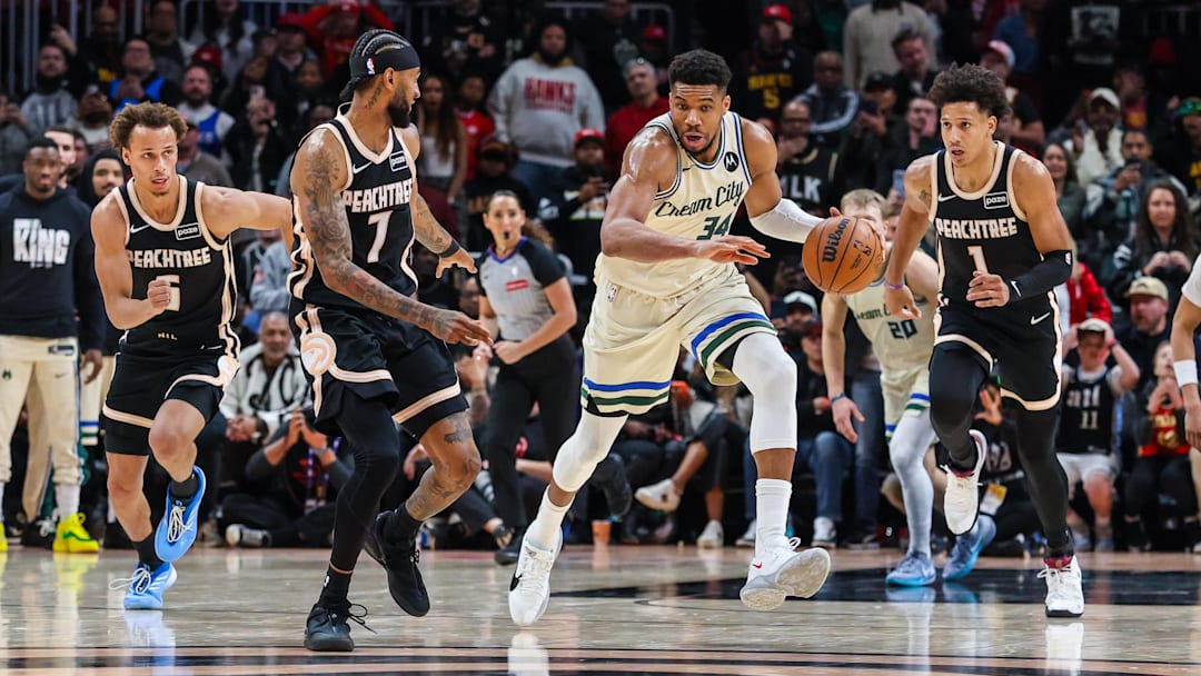 Milwaukee Bucks forward Giannis Antetokounmpo (34) dribbling in transition against Atlanta Hawks guard Dyson Daniels (5), guard Nickeil Alexander-Walker (7) and forward Jalen Johnson (1) during the fourth quarter at State Farm Arena. 