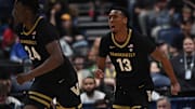 Mar 13, 2024; Nashville, TN, USA; Vanderbilt Commodores guard Malik Presley (13) celebrates after a basket during the first half against the Arkansas Razorbacks at Bridgestone Arena. Mandatory Credit: Christopher Hanewinckel-Imagn Images