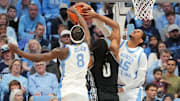 Dec 7, 2025; Chapel Hill, North Carolina, USA; North Carolina Tar Heels forward Caleb Wilson (8) and forward Jarin Stevenson (15) block the shot of Georgetown Hoyas forward Jayden Fort (0) in the second half at Dean E. Smith Center. Mandatory Credit: Bob Donnan-Imagn Images
