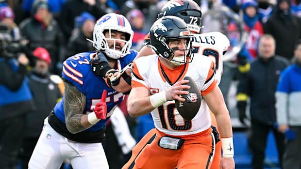 Jan 12, 2025; Orchard Park, New York, USA; Denver Broncos quarterback Bo Nix (10) moves to avoid pressure from Buffalo Bills 