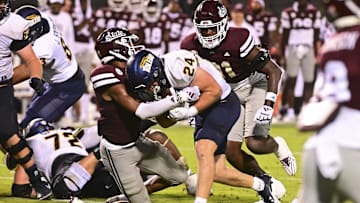 Sep 14, 2024; Starkville, Mississippi, USA; Toledo Rockets running back Connor Walendzak (24) runs the ball while defended by Mississippi State Bulldogs safety Isaac Smith (2) at Davis Wade Stadium at Scott Field. Mandatory Credit: Matt Bush-Imagn Images