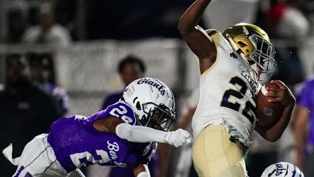 Cathedral running back Xavier Dangerfield (22) gets tackled by Ben Davis defense.