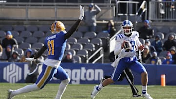 Nov 19, 2022; Pittsburgh, Pennsylvania, USA;  Duke Blue Devils quarterback Riley Leonard (13) looks to pass the ball as Pittsburgh Panthers linebacker Bangally Kamara (11) defends during the second quarter at Acrisure Stadium. Mandatory Credit: Charles LeClaire-Imagn Images