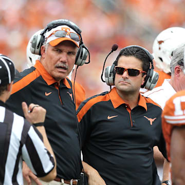 Oct 8, 2011; Dallas, TX, USA; Texas Longhorns assistant head coach Duane Akina and defensive coordinator Manny Diaz on the sidelines during the second quarter against the Oklahoma Sooners for the red river rivalry at the Cotton Bowl.  Mandatory Credit: Matthew Emmons-Imagn Images