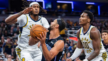 Nov 6, 2024; Indianapolis, Indiana, USA; Orlando Magic guard Jalen Suggs (4) shoots the ball while Indiana Pacers center Myles Turner (33) defends in the second half at Gainbridge Fieldhouse. Mandatory Credit: Trevor Ruszkowski-Imagn Images