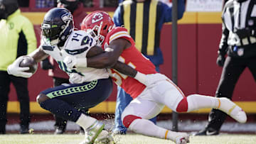 Dec 24, 2022; Kansas City, Missouri, USA; Seattle Seahawks wide receiver DK Metcalf (14) is tackled by Kansas City Chiefs linebacker Nick Bolton (32) during the first half at GEHA Field at Arrowhead Stadium. Mandatory Credit: Denny Medley-Imagn Images
