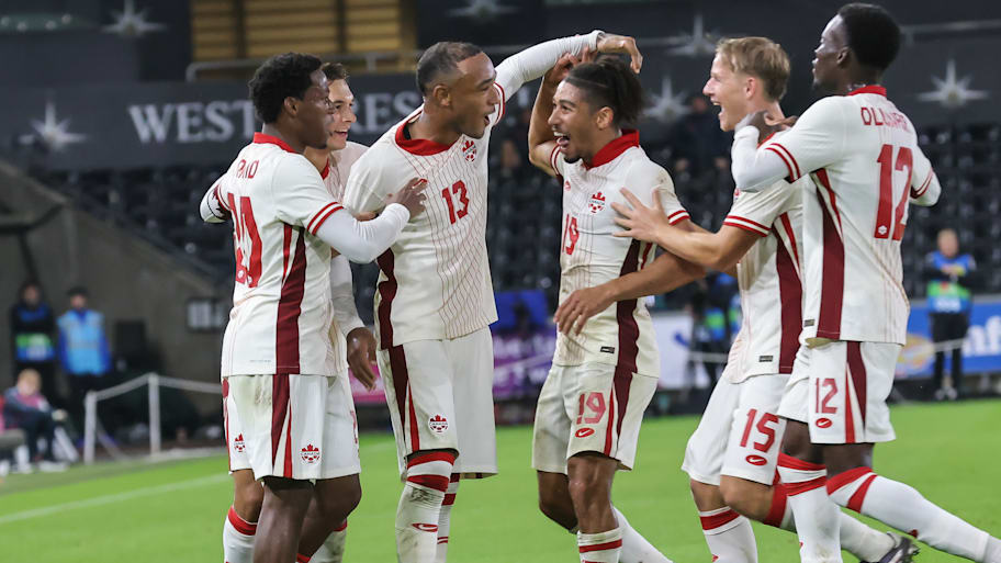 Canada’s players celebrate scoring against Wales
