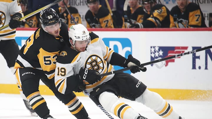 Mar 1, 2025; Pittsburgh, Pennsylvania, USA;  Pittsburgh Penguins center Philip Tomasino (53) defends Boston Bruins center John Beecher (19) during the second period at PPG Paints Arena. Mandatory Credit: Charles LeClaire-Imagn Images