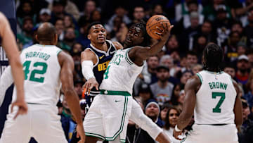 Jan 7, 2025; Denver, Colorado, USA; Boston Celtics guard Jrue Holiday (4) and Denver Nuggets guard Russell Westbrook (4) battle for the ball as center Al Horford (42) and guard Jaylen Brown (7) in the third quarter at Ball Arena. Mandatory Credit: Isaiah J. Downing-Imagn Images