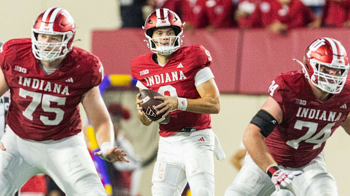 Indiana Hoosiers quarterback Kurtis Rourke (9) looks to pass the ball  as offensive linemen Trey Wedig (75) and Bray Lynch (74) block against Western Illinois at Memorial Stadium.