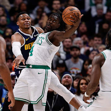 Jan 7, 2025; Denver, Colorado, USA; Boston Celtics guard Jrue Holiday (4) and Denver Nuggets guard Russell Westbrook (4) battle for the ball as center Al Horford (42) and guard Jaylen Brown (7) in the third quarter at Ball Arena. Mandatory Credit: Isaiah J. Downing-Imagn Images