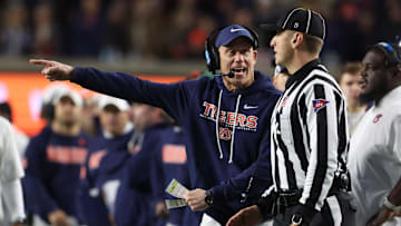 Nov 29, 2025; Auburn, Alabama, USA; Auburn Tigers interim head coach DJ Durkin talks to a referee during the second half against the Alabama Crimson Tide at Jordan-Hare Stadium. Mandatory Credit: John Reed-Imagn Images