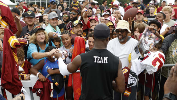 Washington Commanders receiver Terry McLaurin signing autographs after training camp practice.