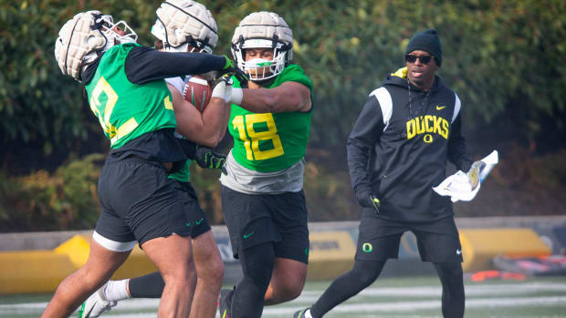 New co-defensive coordinator and safeties coach Chris Hampton, right, joins the first practice of spring for Oregon football 