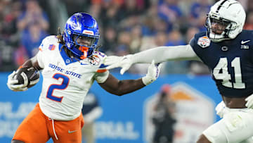 Boise State Broncos running back Ashton Jeanty (2) runs past Penn State Nittany Lions linebacker Kobe King (41) during their Vrbo Fiesta Bowl matchup at State Farm Stadium on Dec. 31, 2024.